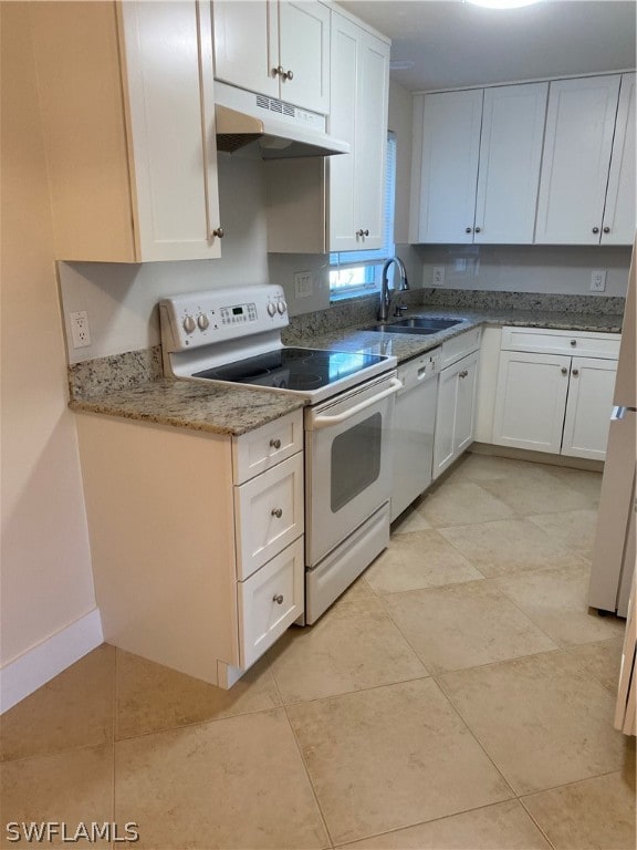 kitchen with white appliances, white cabinets, and sink