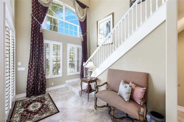 entrance foyer with a high ceiling and light tile flooring