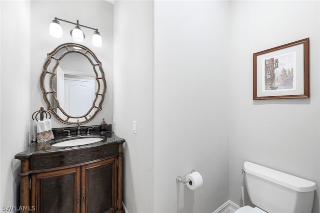 bathroom featuring toilet and vanity