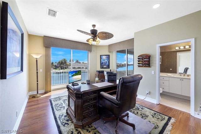 office area featuring light hardwood / wood-style flooring and ceiling fan