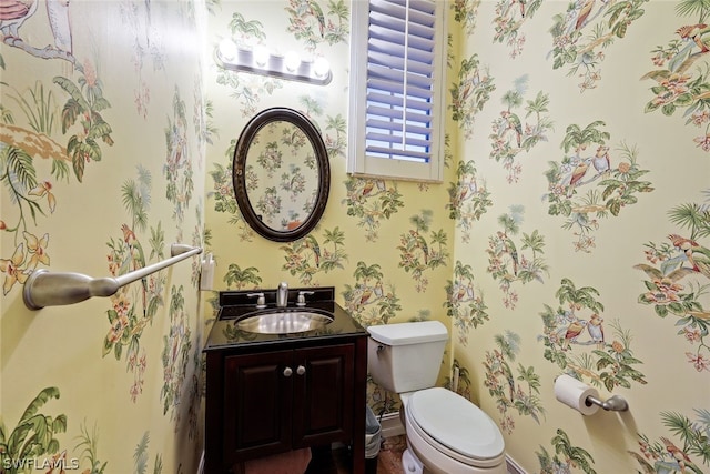 bathroom featuring toilet and large vanity