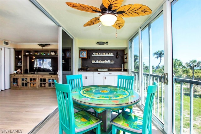 sunroom featuring ceiling fan and visible vents