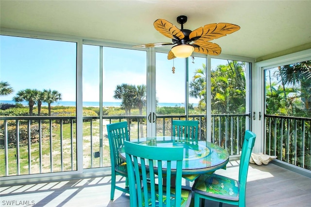 sunroom featuring a ceiling fan and a wealth of natural light