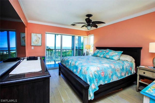 bedroom with a water view, access to exterior, ceiling fan, hardwood / wood-style flooring, and crown molding