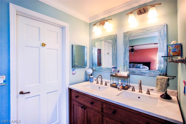 bathroom featuring ornamental molding, double sink, ceiling fan, and vanity with extensive cabinet space