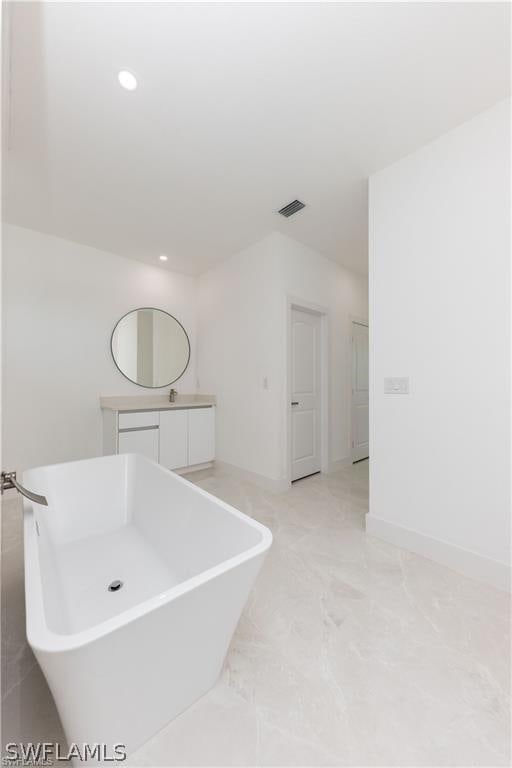 bathroom featuring tile flooring and vanity with extensive cabinet space