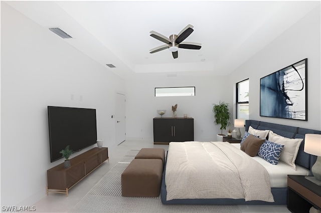 bedroom with ceiling fan and a raised ceiling