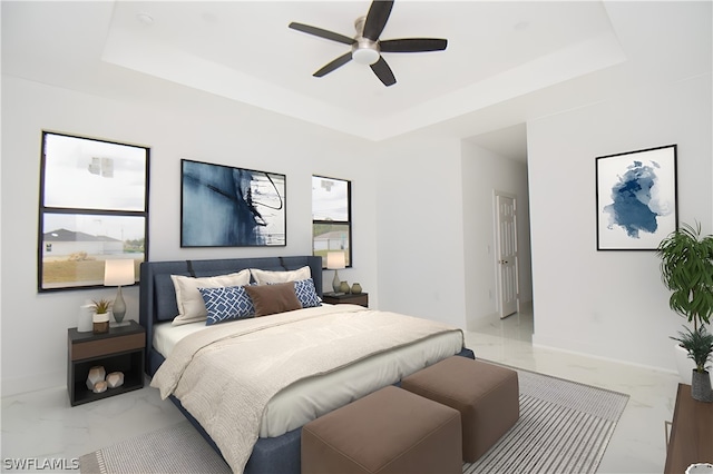 bedroom with a tray ceiling, ceiling fan, and tile floors