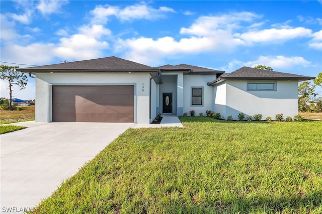 view of front of house featuring a garage and a front yard