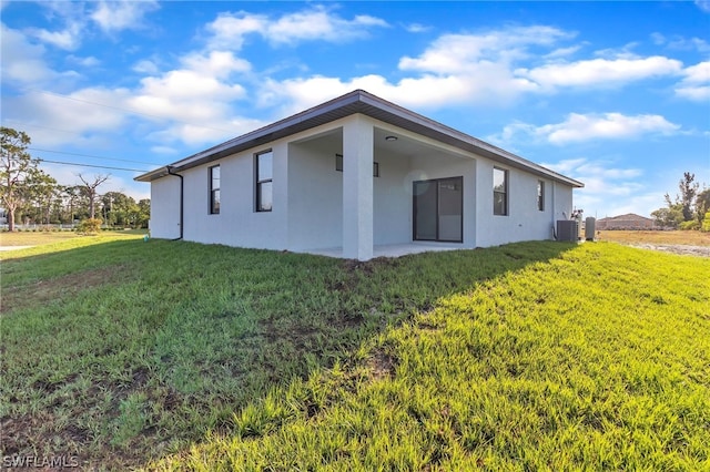 view of home's exterior with a lawn and central air condition unit