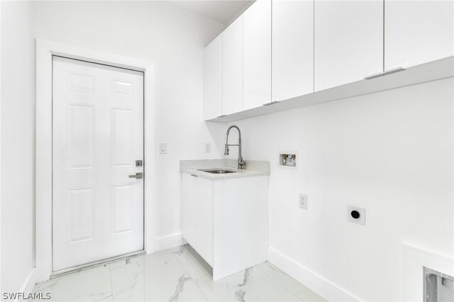 laundry area featuring cabinets, sink, hookup for an electric dryer, and light tile flooring