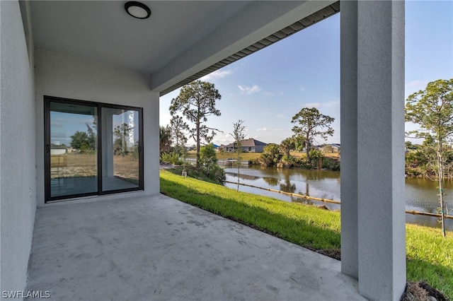 view of terrace with a water view