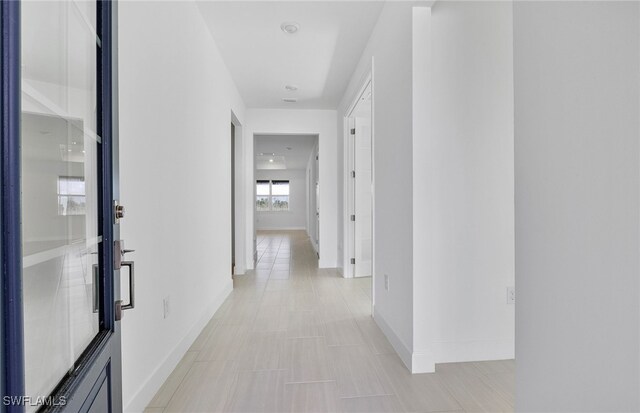 hallway with light tile patterned floors