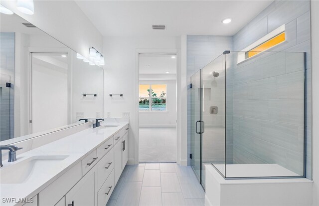 bathroom with vanity, tile patterned floors, and walk in shower