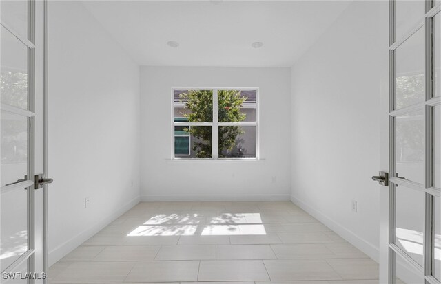 spare room featuring light tile patterned floors