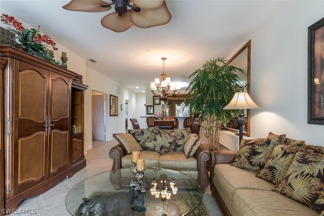 living room with ceiling fan with notable chandelier and light tile floors