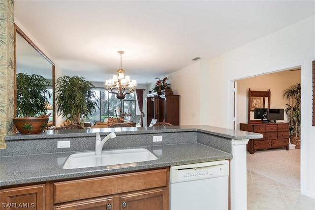 kitchen with decorative light fixtures, light tile floors, sink, dishwasher, and an inviting chandelier