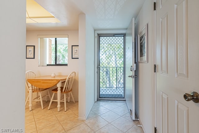 doorway to outside featuring light tile floors