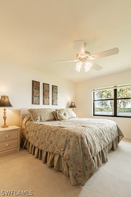 bedroom featuring ceiling fan and light colored carpet