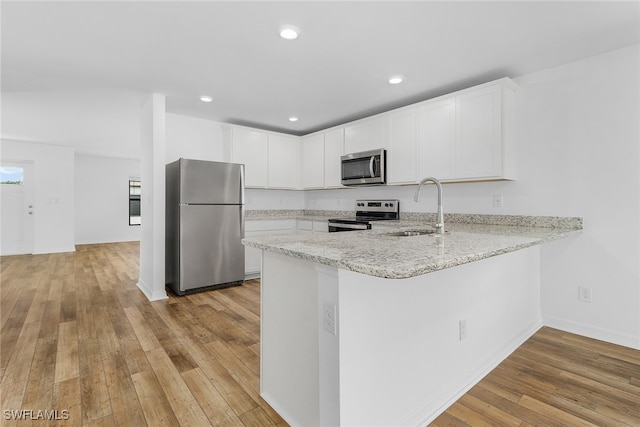 kitchen featuring light hardwood / wood-style flooring, white cabinets, stainless steel appliances, and sink