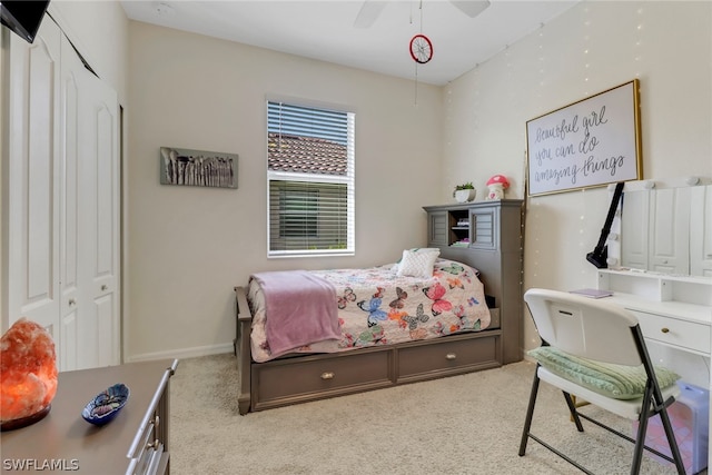 carpeted bedroom featuring a closet and ceiling fan