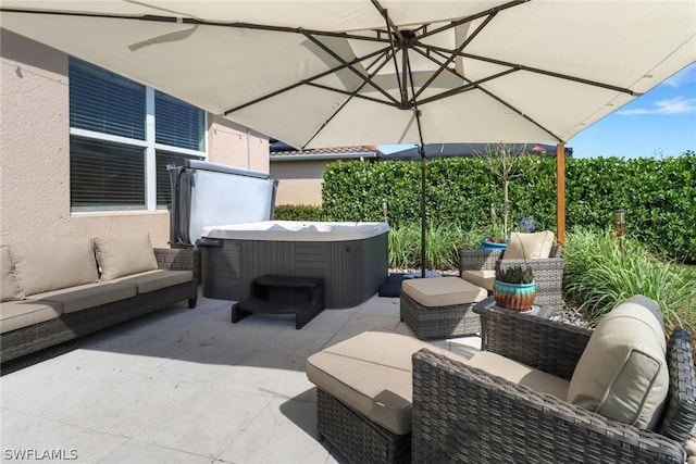 view of patio / terrace featuring an outdoor hangout area and a hot tub