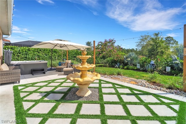 view of patio / terrace with a hot tub