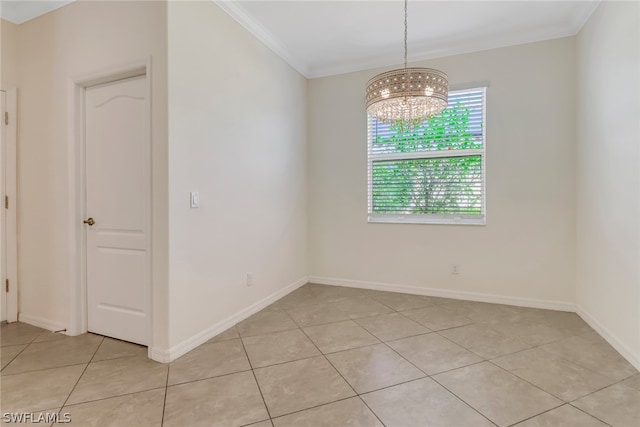 spare room with light tile patterned flooring, a chandelier, and ornamental molding