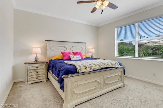 carpeted bedroom with ceiling fan and crown molding