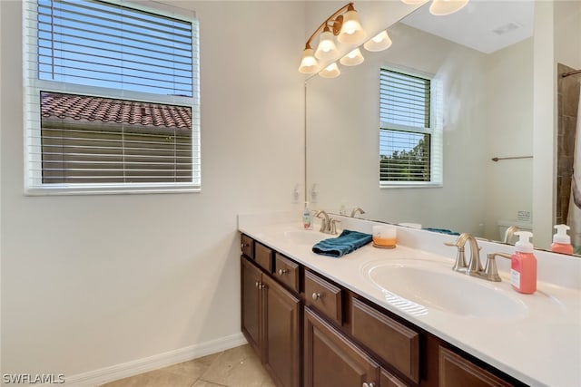 bathroom with tile patterned flooring, vanity, and toilet