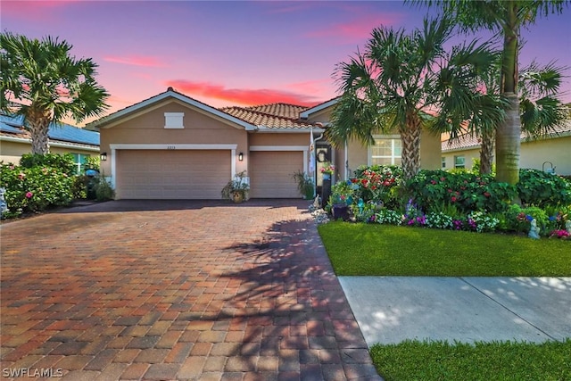 view of front of home with a yard and a garage