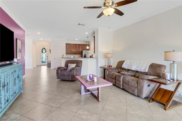 living room with ceiling fan, light tile patterned flooring, and ornamental molding