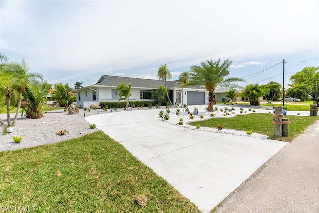 single story home with a front lawn and a garage