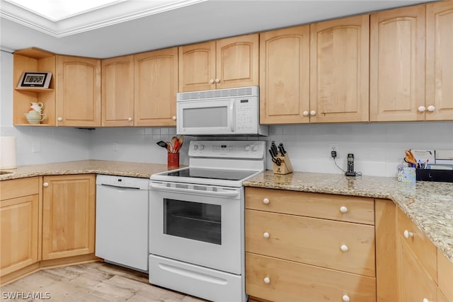 kitchen featuring light stone counters, white appliances, light brown cabinetry, and light hardwood / wood-style flooring