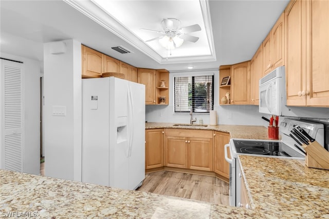 kitchen with ceiling fan, light brown cabinets, a raised ceiling, white appliances, and light wood-type flooring