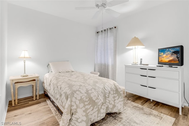 bedroom with ceiling fan and light hardwood / wood-style floors