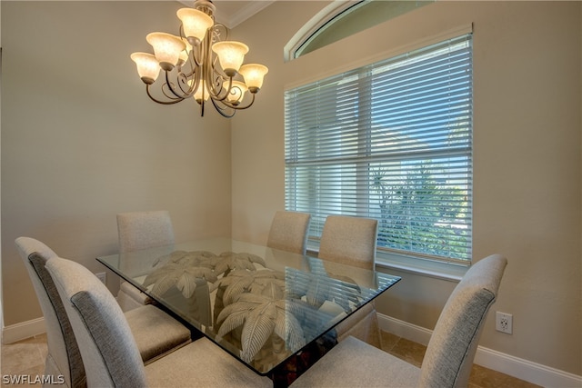 dining room with light tile floors, a chandelier, and ornamental molding