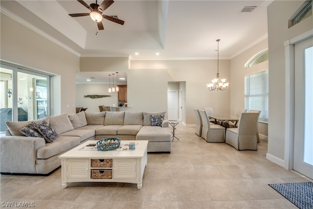 living room featuring a raised ceiling, crown molding, ceiling fan with notable chandelier, and light tile floors