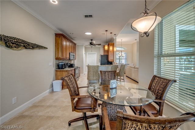 dining room with light tile floors, ornamental molding, and ceiling fan