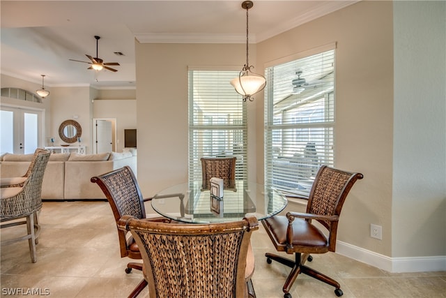 dining area featuring light tile floors, ceiling fan, french doors, and crown molding