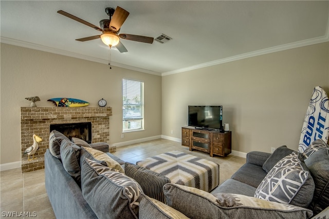 living room with ceiling fan, a brick fireplace, light tile floors, and crown molding