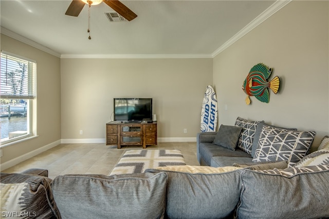 tiled living room featuring ceiling fan and ornamental molding