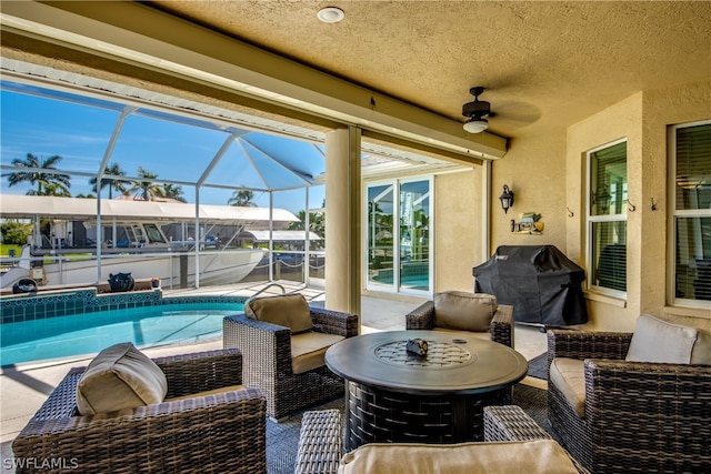 view of patio featuring an outdoor living space, ceiling fan, glass enclosure, and a grill