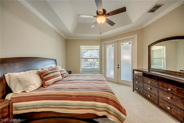 carpeted bedroom with french doors, crown molding, a tray ceiling, and ceiling fan