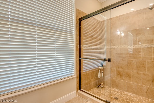 bathroom with tile flooring and an enclosed shower