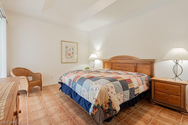 tiled bedroom featuring a tray ceiling