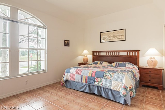 bedroom featuring multiple windows and tile patterned flooring