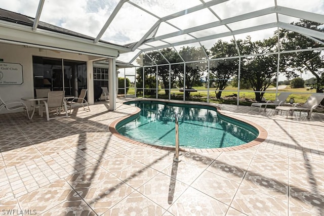 view of swimming pool with a patio and glass enclosure