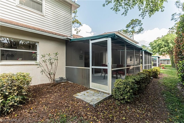 374 Dover Pl Unit 803, Naples, FL 34104 - view of property exterior with stucco siding and a sunroom