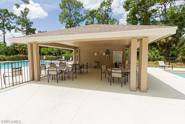 374 Dover Pl Unit 803, Naples, FL 34104 - view of patio featuring a community pool, a gazebo, and fence